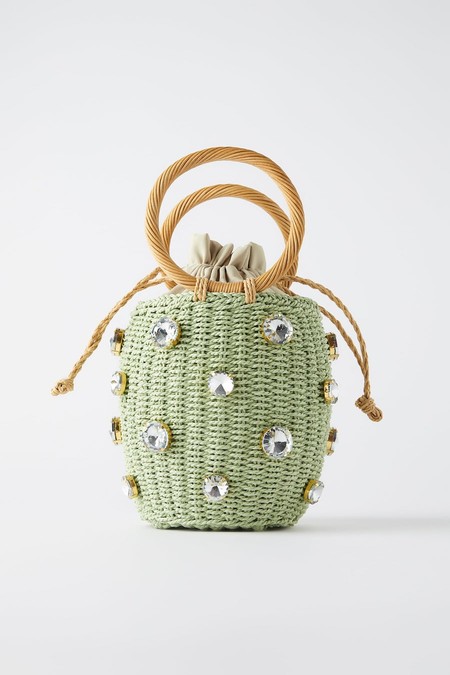 Green basket format bag. Braided body with jewellery detail. Circular handgrips.