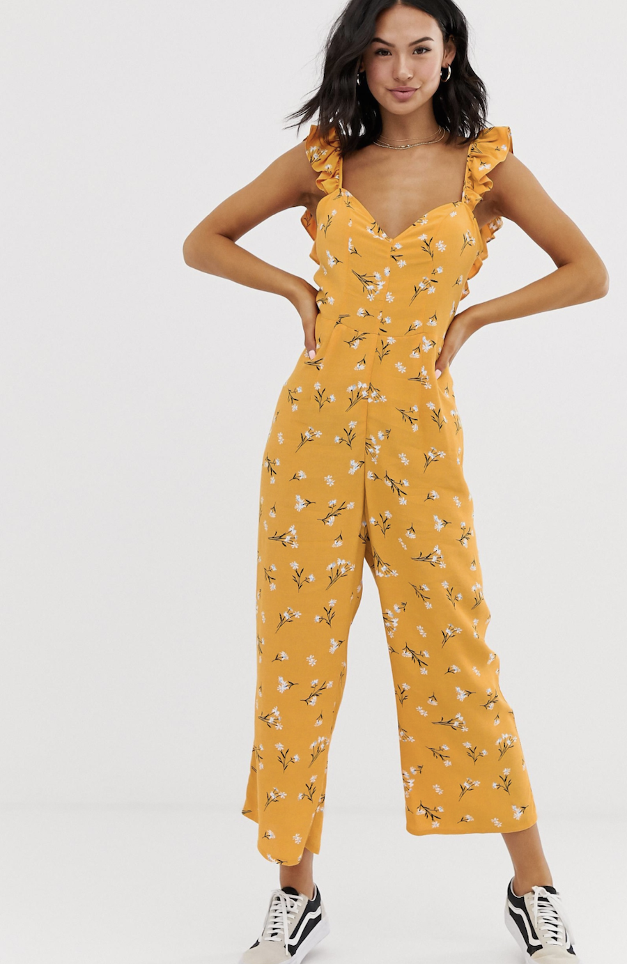 Long yellow jumpsuit with ruffles on the straps, floral print and bow on the back of ASOS DESIGN