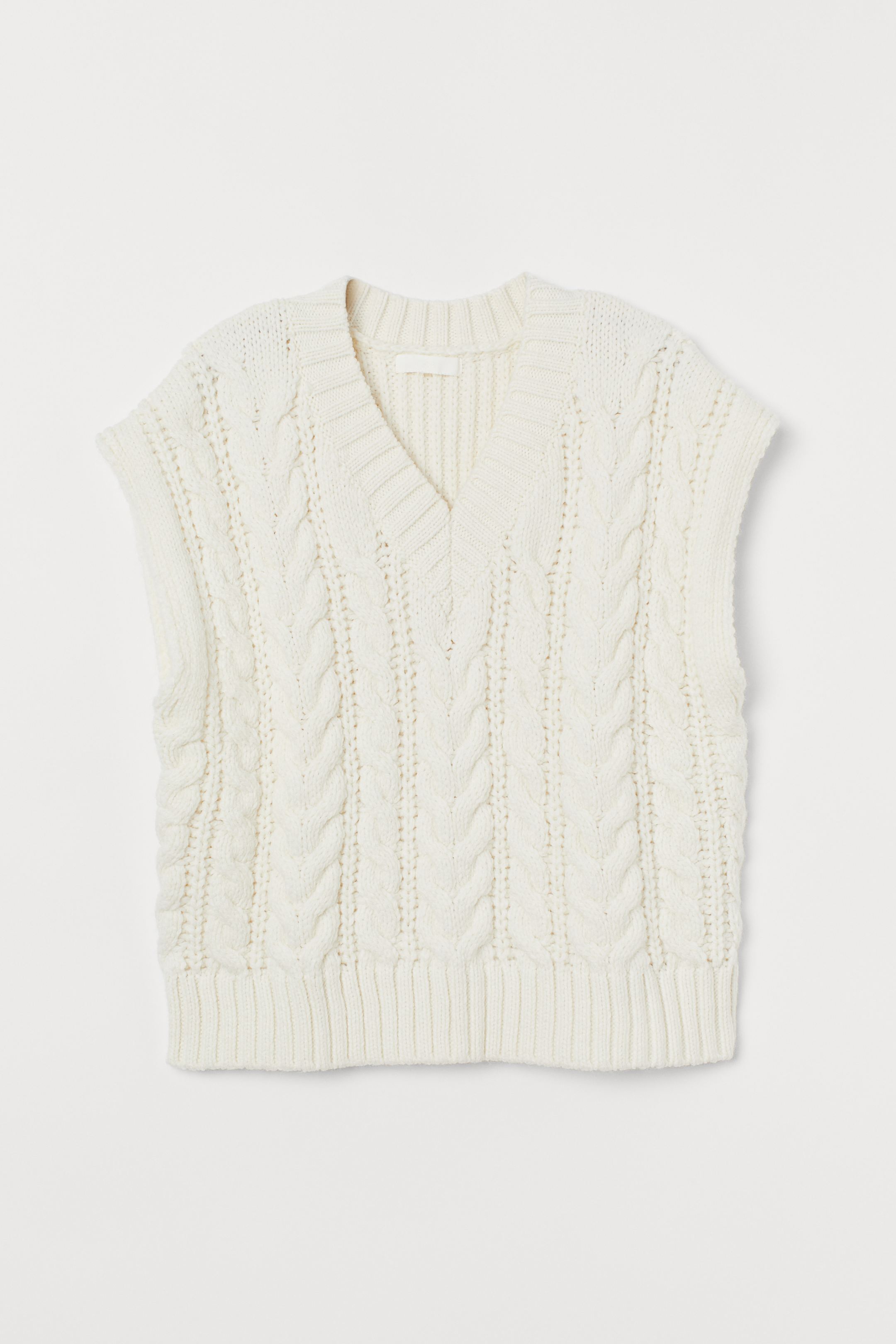 Soft knitted vest with v-neck. Relaxed cut model with neck and low in ribbed point. Made from recycled polyester.