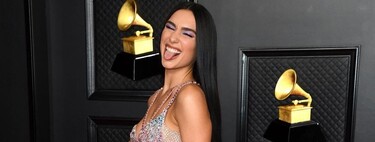 Dua Lipa scores a full-blown look in a Versace dress full of glitter and transparencies at the 2021 Grammy Awards.