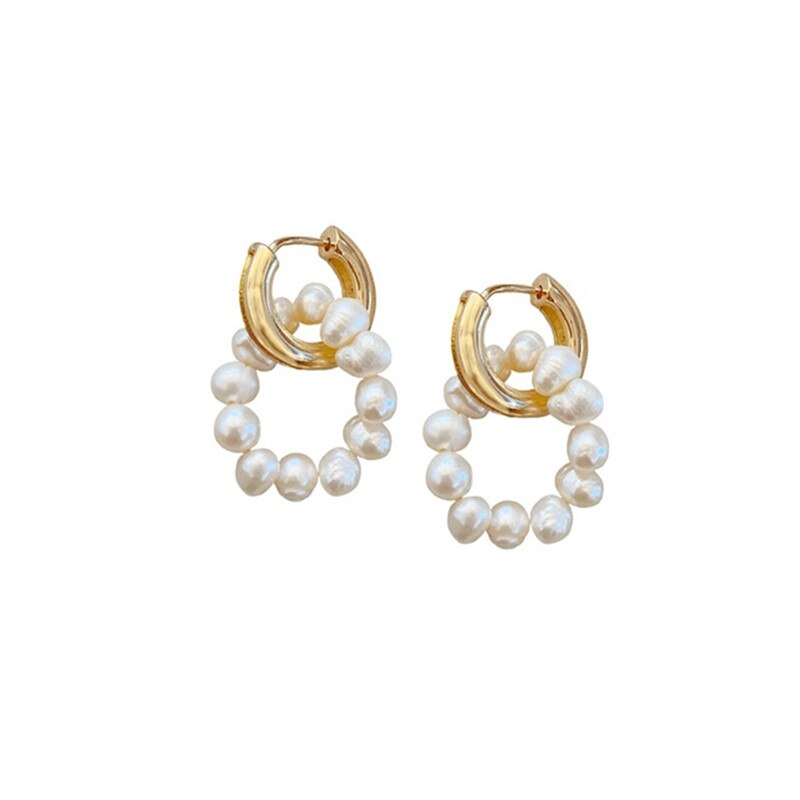 Golden hoop earrings with pearl detail.