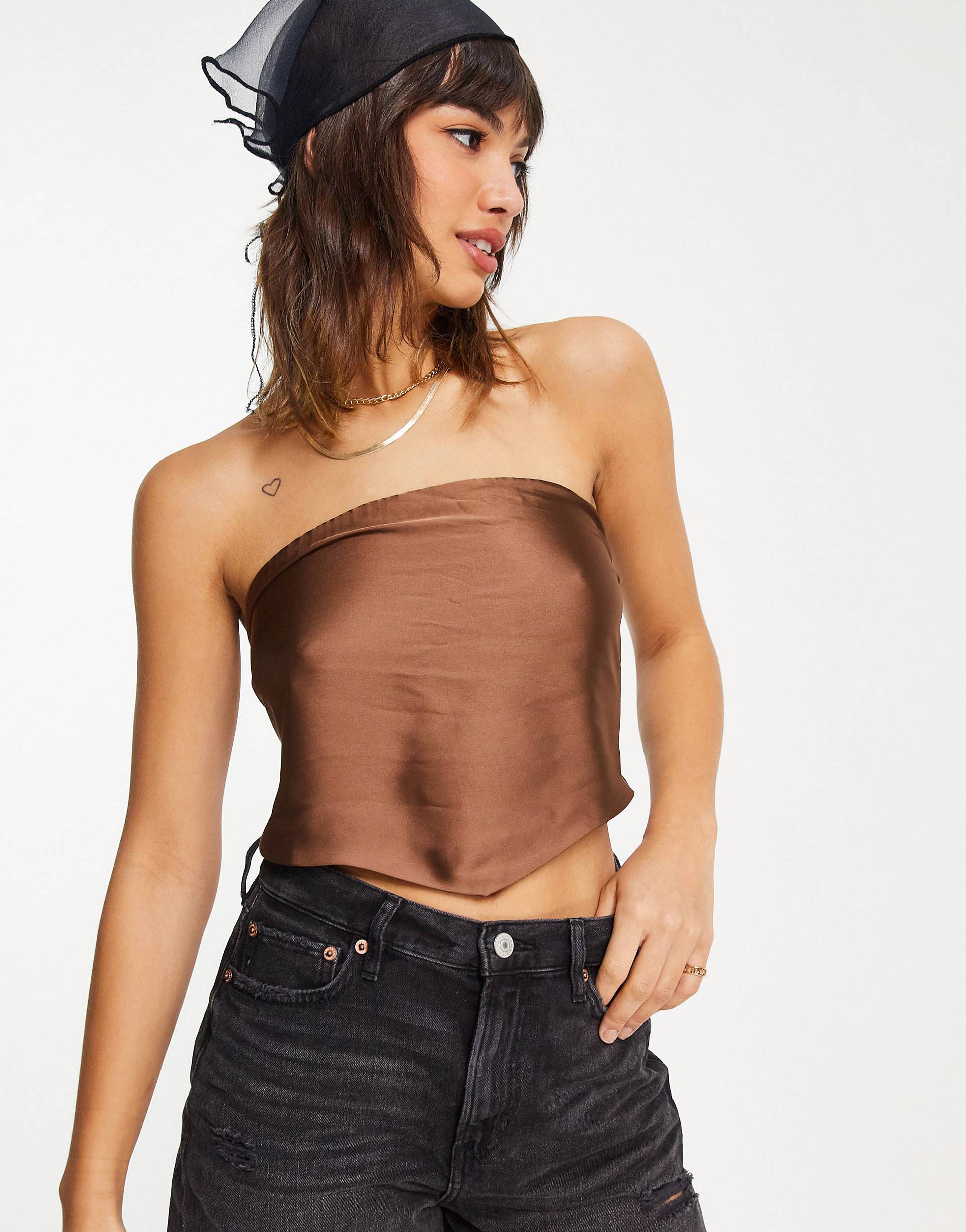 Brown top with scooped hem and knotted design at the back in satin.