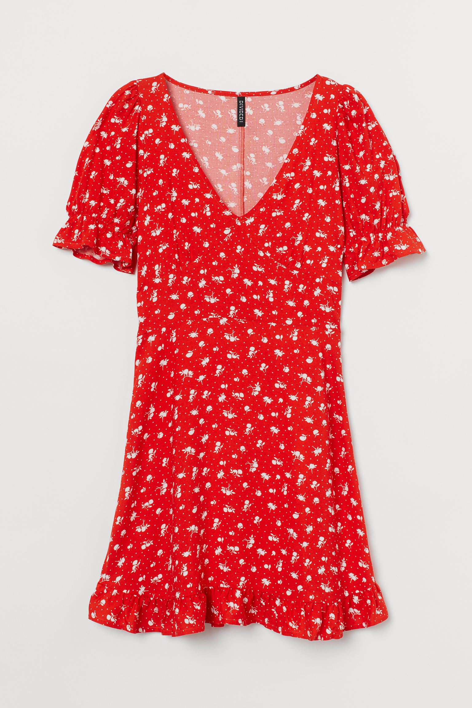 Short printed dress in viscose with V-neckline and seam under the bust. Model with short puffed sleeves with elastic and ruffle trim, sewn straps at the back of the waist and hidden zipper on one side.